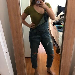 Distressed denim overalls